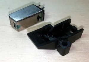 Phono cartridge removed from mounting bracket